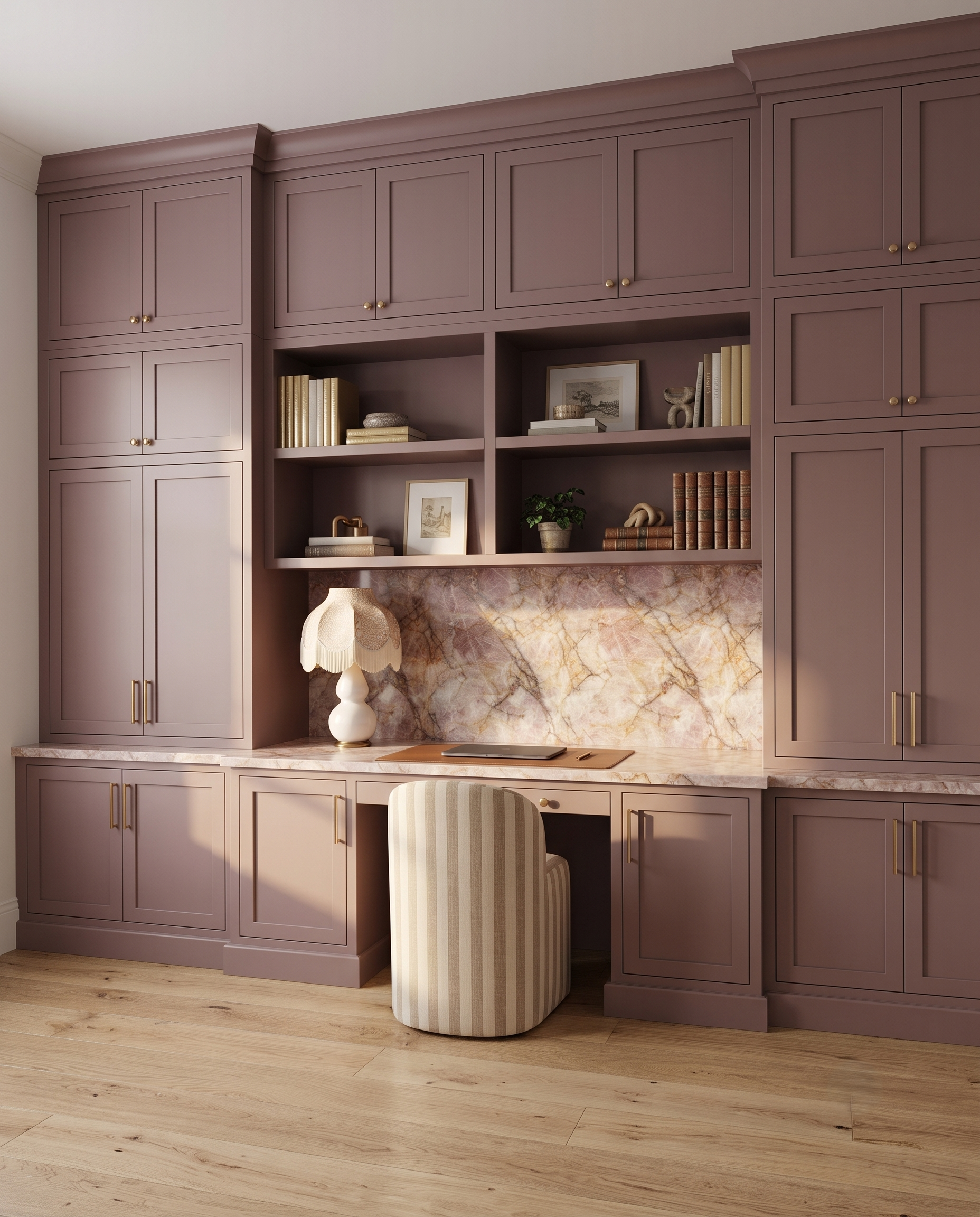 Mauve colored built in office cabinets with light wood floors